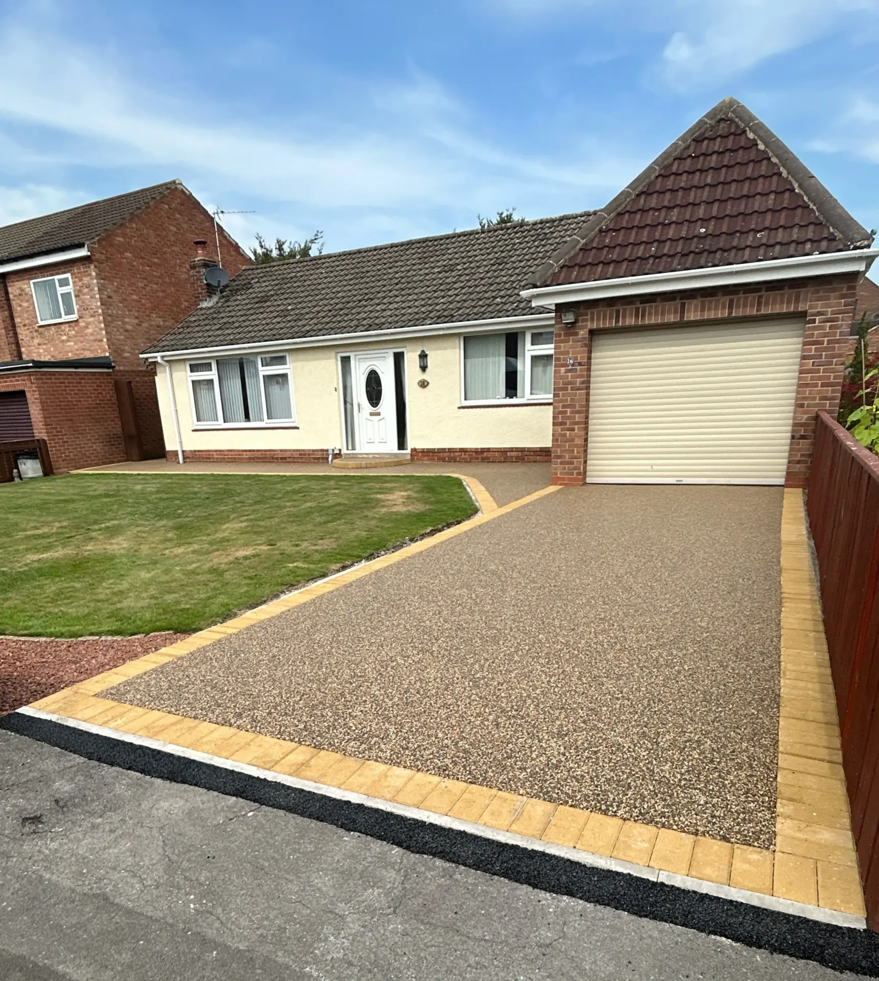 Golden resin bound driveway with contrasting block edging